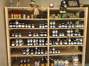 whispering orchards store shelves have jam and pure maple syrup